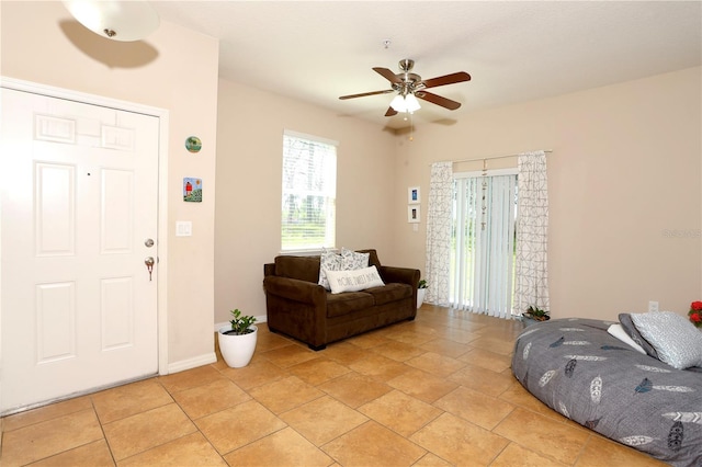 foyer entrance featuring a ceiling fan and baseboards