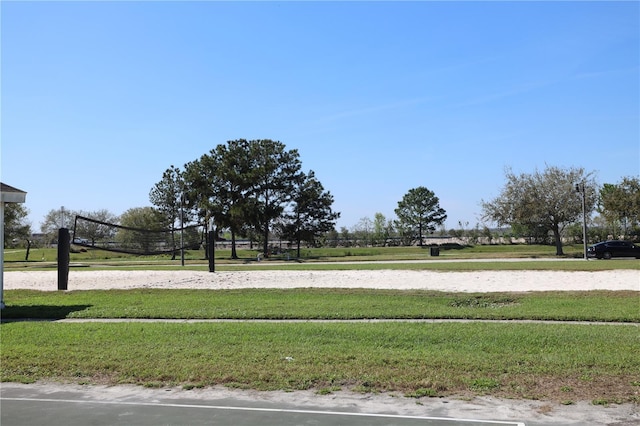 view of community with a yard and volleyball court