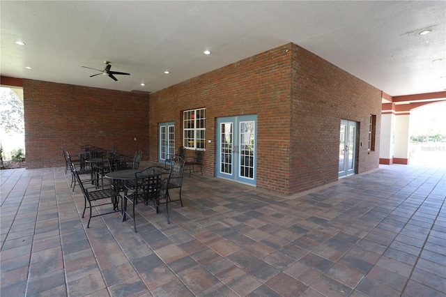 view of patio featuring ceiling fan, french doors, and outdoor dining space