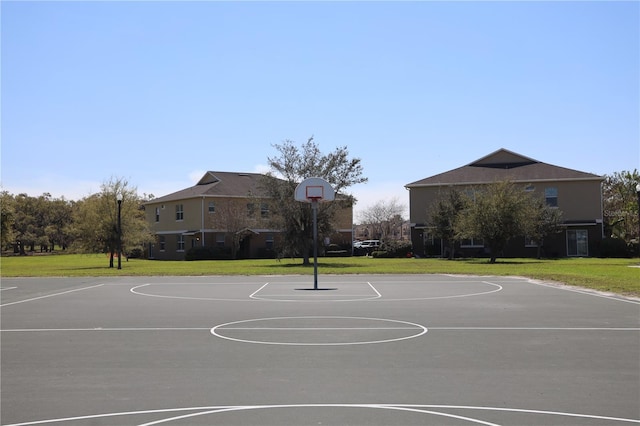 view of sport court featuring community basketball court and a lawn