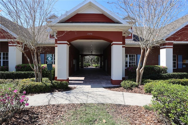 doorway to property with brick siding