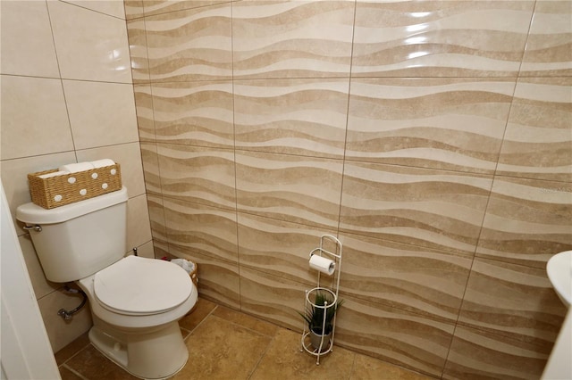 bathroom with tile walls and toilet