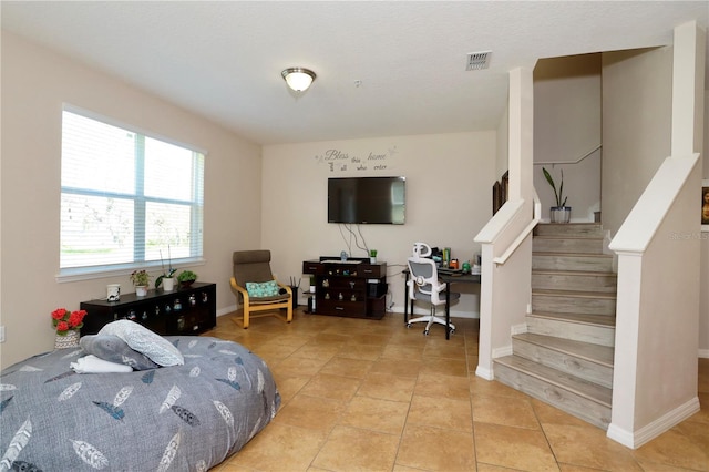 bedroom featuring visible vents, baseboards, and light tile patterned flooring