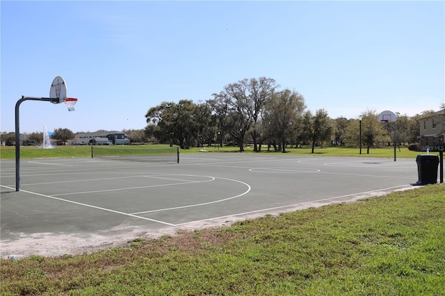 view of sport court featuring community basketball court and a lawn