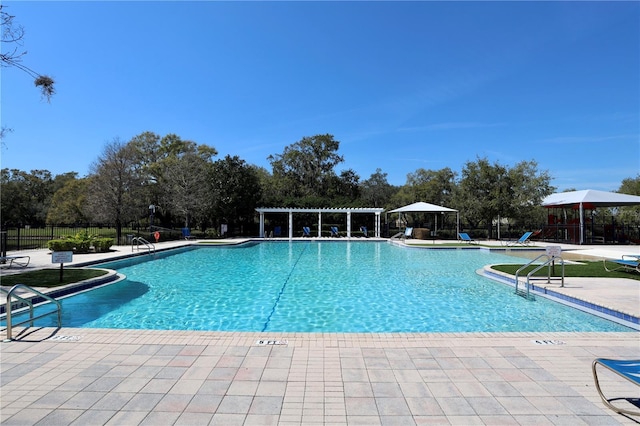 community pool featuring a pergola, a patio, and fence