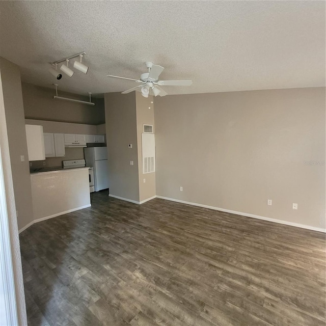 unfurnished living room with dark wood-style floors, visible vents, ceiling fan, and baseboards