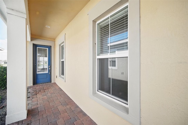 property entrance with stucco siding