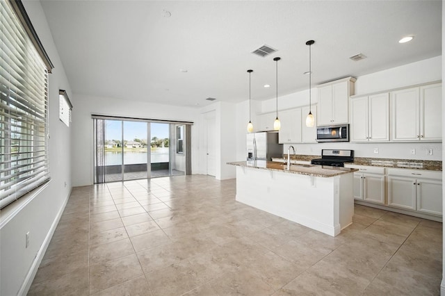 kitchen featuring appliances with stainless steel finishes, open floor plan, visible vents, and a sink