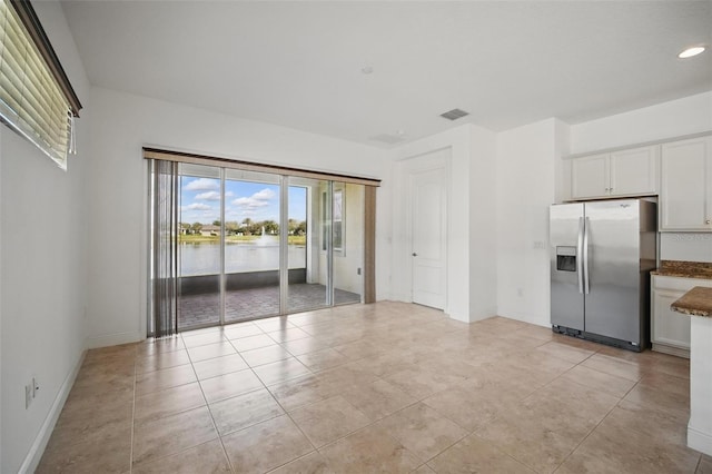 interior space featuring recessed lighting, visible vents, baseboards, and light tile patterned floors