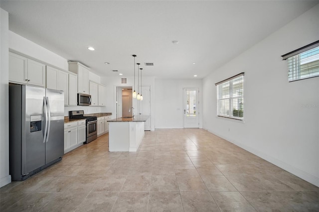 kitchen with visible vents, white cabinets, an island with sink, appliances with stainless steel finishes, and recessed lighting