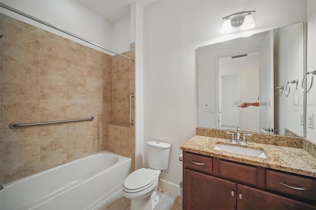 bathroom with tub / shower combination, vanity, toilet, and baseboards