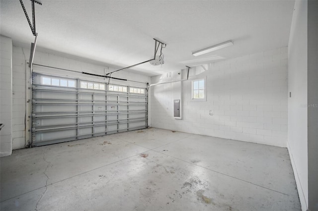 garage featuring electric panel and concrete block wall