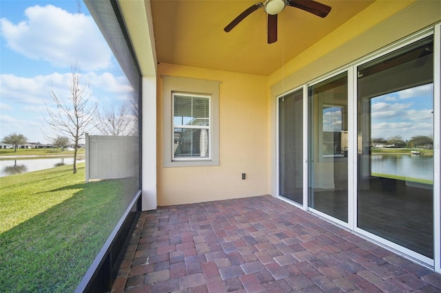 exterior space with a water view and ceiling fan