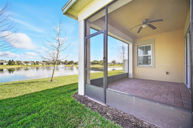 exterior space featuring a water view and a ceiling fan