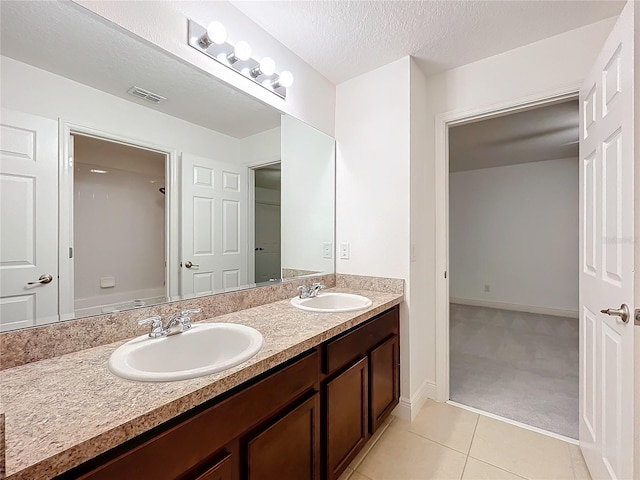 bathroom with double vanity, tile patterned flooring, a sink, and visible vents