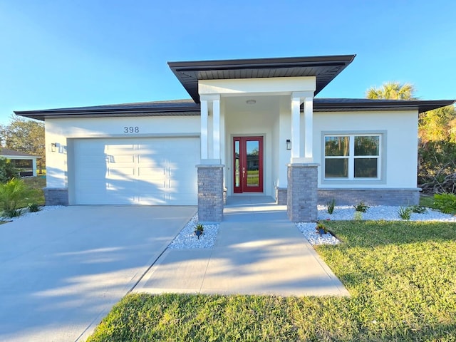 view of front facade featuring an attached garage, stucco siding, concrete driveway, french doors, and stone siding