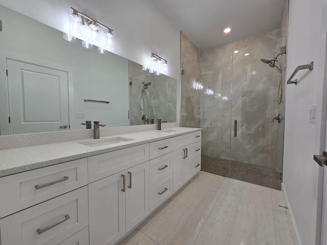 full bathroom featuring a shower stall, double vanity, tile patterned floors, and a sink