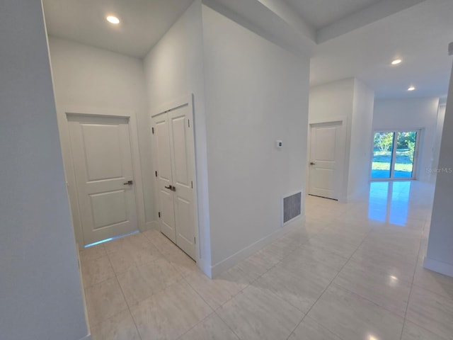 hall featuring recessed lighting, visible vents, and baseboards