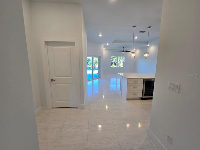 corridor with wine cooler, recessed lighting, and baseboards