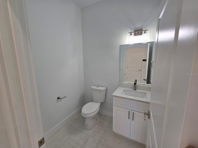 bathroom with tile patterned floors, baseboards, toilet, and vanity