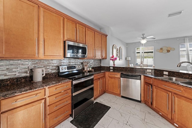 kitchen featuring marble finish floor, stainless steel appliances, a sink, and visible vents