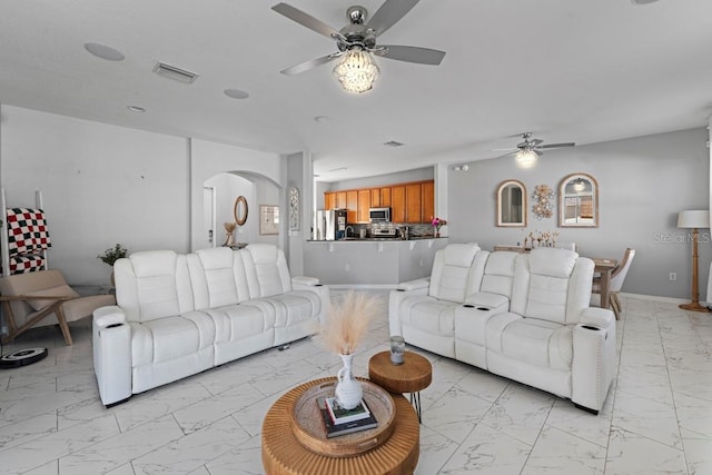 living area with baseboards, visible vents, arched walkways, a ceiling fan, and marble finish floor