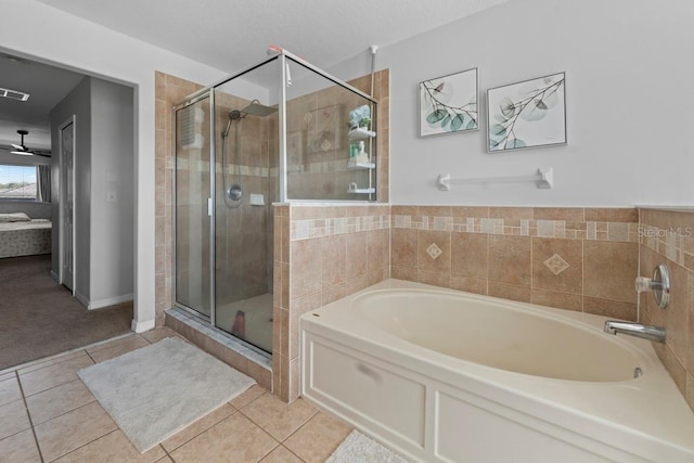 bathroom with a garden tub, a shower stall, and tile patterned floors