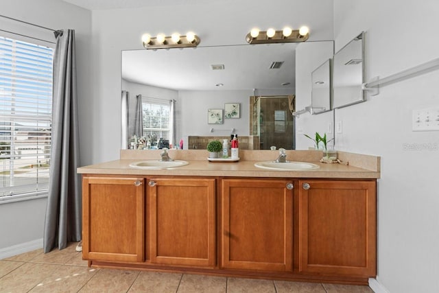 full bath featuring a stall shower, tile patterned floors, a sink, and double vanity