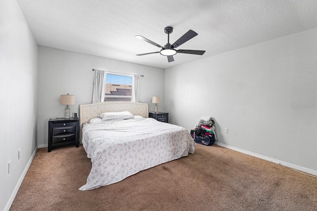 carpeted bedroom featuring ceiling fan, a textured ceiling, and baseboards