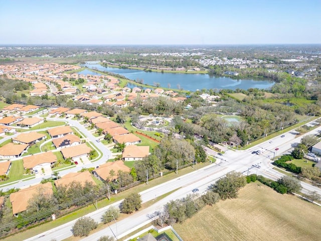 drone / aerial view featuring a water view and a residential view