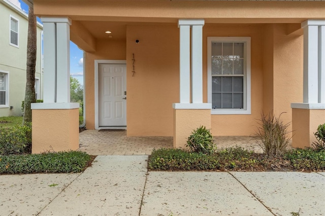 view of exterior entry with stucco siding