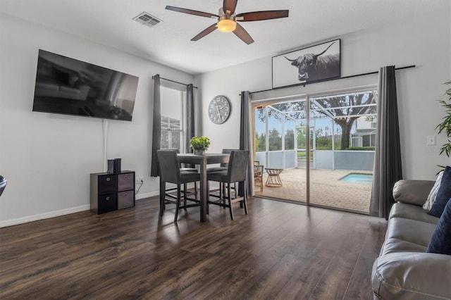 dining area featuring baseboards, wood finished floors, visible vents, and ceiling fan