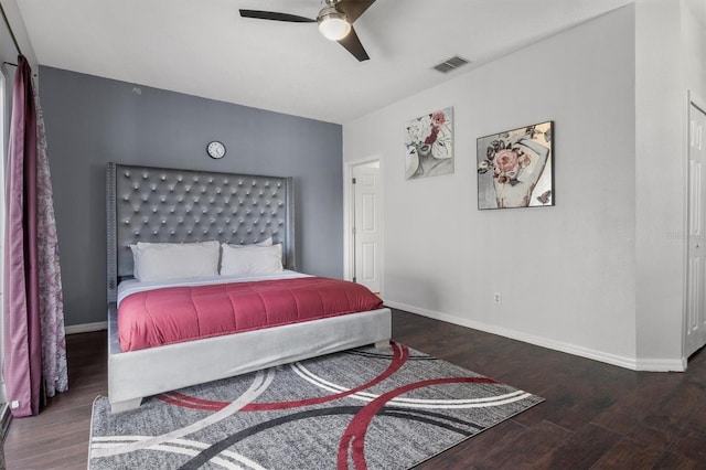 bedroom with visible vents, baseboards, and wood finished floors