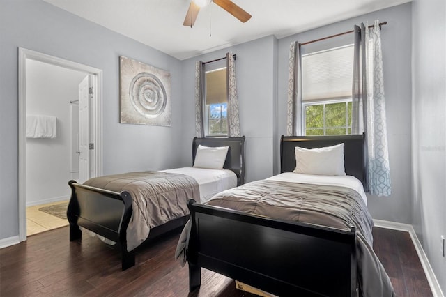 bedroom featuring baseboards, wood finished floors, and a ceiling fan