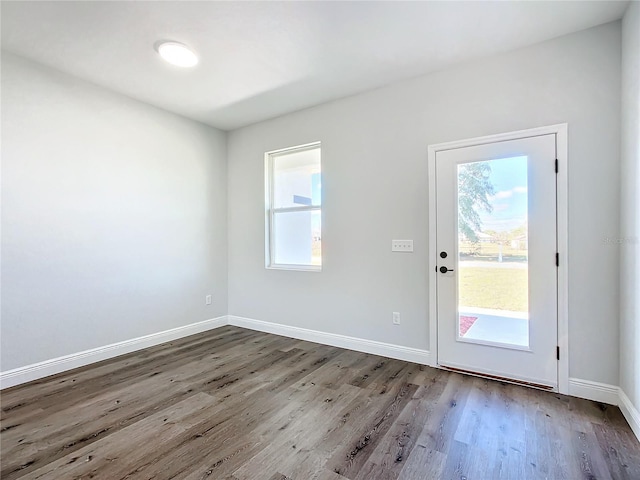 entryway with wood finished floors and baseboards