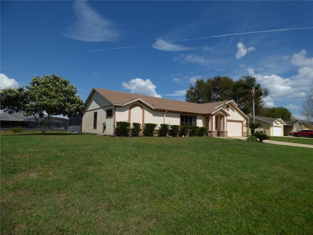 ranch-style home with a garage, a front yard, and driveway