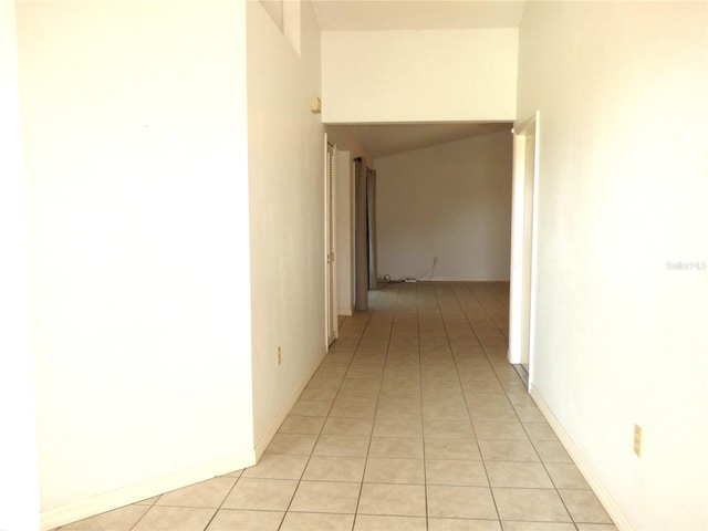 hall with light tile patterned floors