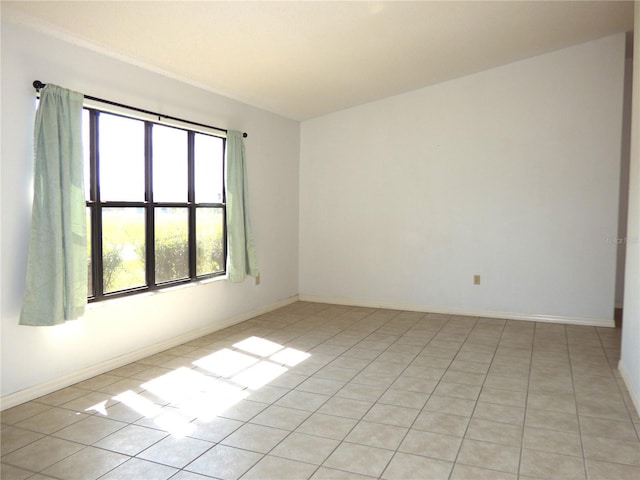 unfurnished room with baseboards and light tile patterned floors