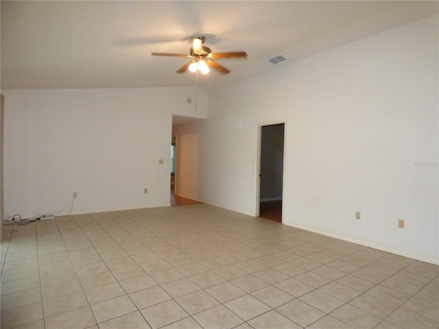 spare room featuring vaulted ceiling, visible vents, and a ceiling fan