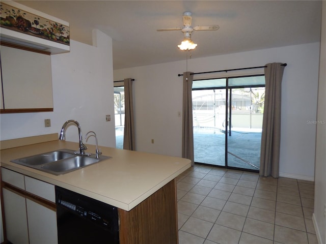 kitchen featuring black dishwasher, white cabinets, light countertops, a sink, and light tile patterned flooring