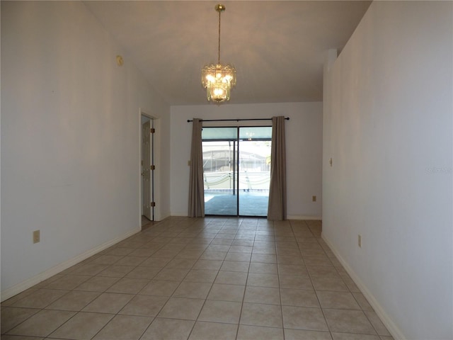 unfurnished room with light tile patterned floors, baseboards, and a notable chandelier