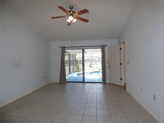 empty room with ceiling fan, high vaulted ceiling, light tile patterned flooring, a sunroom, and baseboards