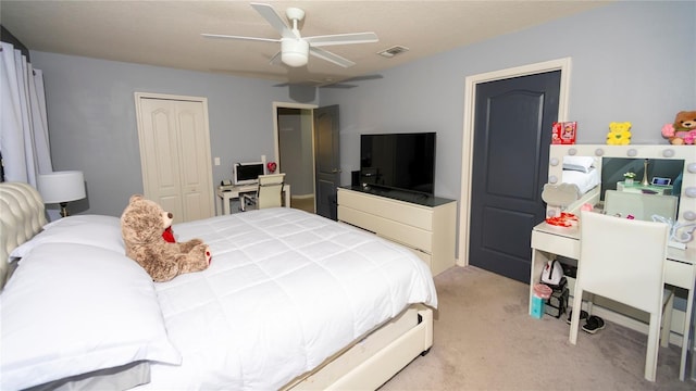 bedroom featuring a closet, visible vents, light colored carpet, and ceiling fan