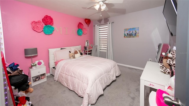 bedroom with a ceiling fan, baseboards, and light carpet