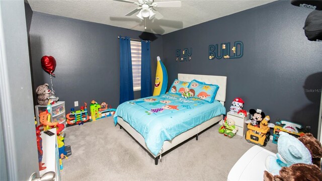 bedroom featuring carpet floors, a textured ceiling, and ceiling fan