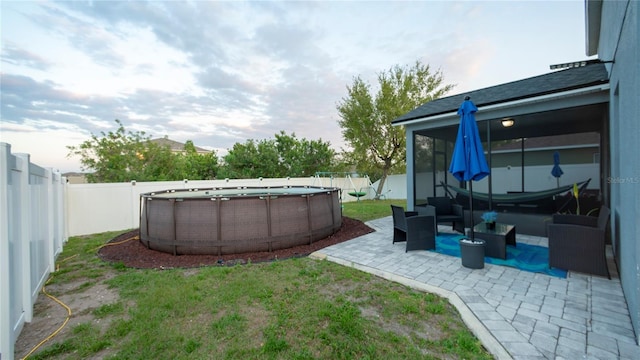 view of yard featuring a fenced in pool, a patio, and a fenced backyard