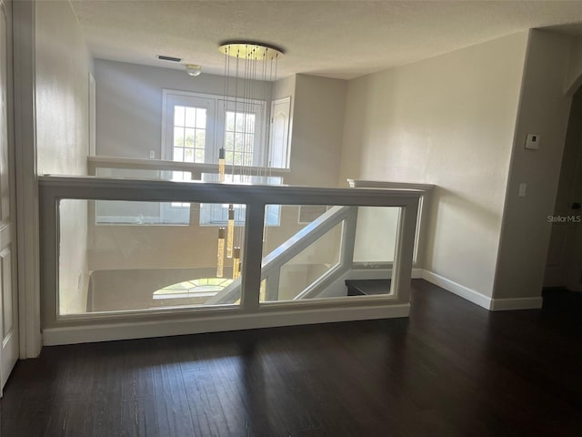 staircase featuring hardwood / wood-style flooring and baseboards