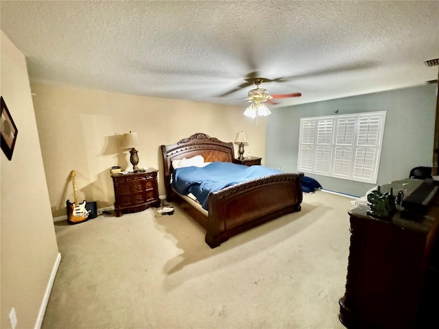 carpeted bedroom featuring a textured ceiling, baseboards, and ceiling fan