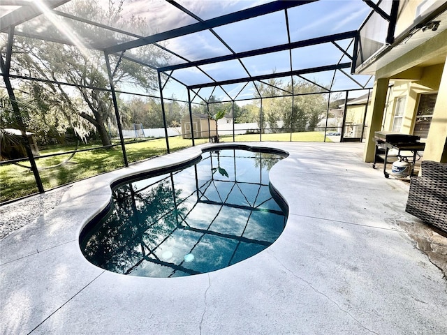 pool featuring glass enclosure, a yard, and a patio area