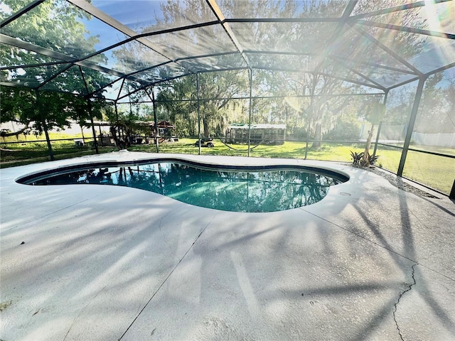 pool with a lanai, a yard, and a patio area